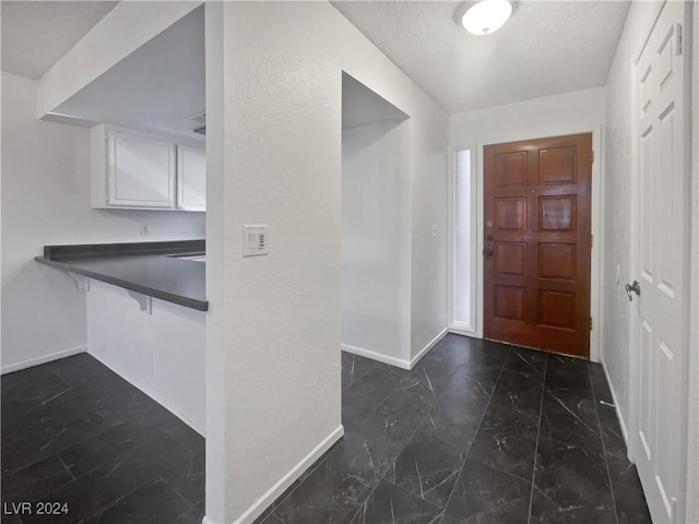 entrance foyer featuring a textured ceiling