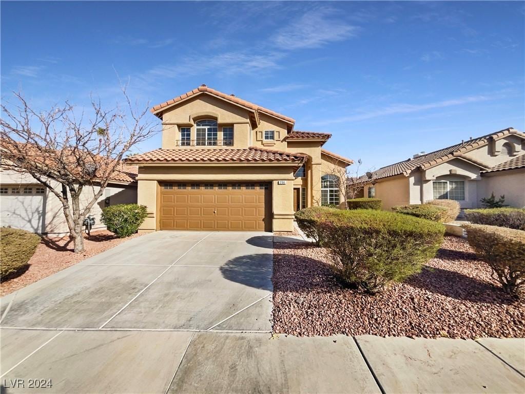 mediterranean / spanish-style home with a garage