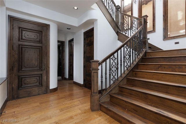 stairs featuring hardwood / wood-style flooring