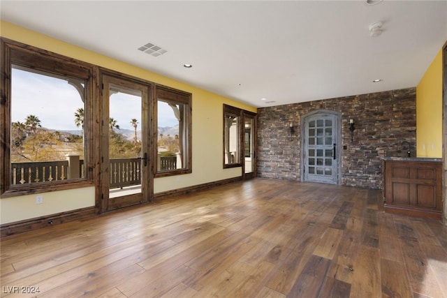 unfurnished living room featuring wood-type flooring