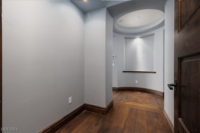 corridor with dark hardwood / wood-style flooring