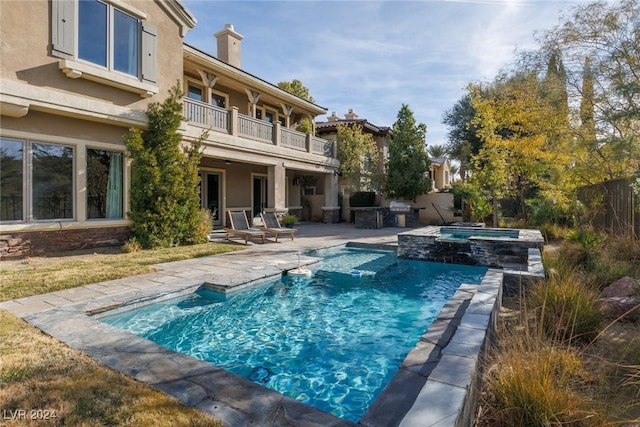 view of swimming pool with a patio area, an in ground hot tub, and grilling area