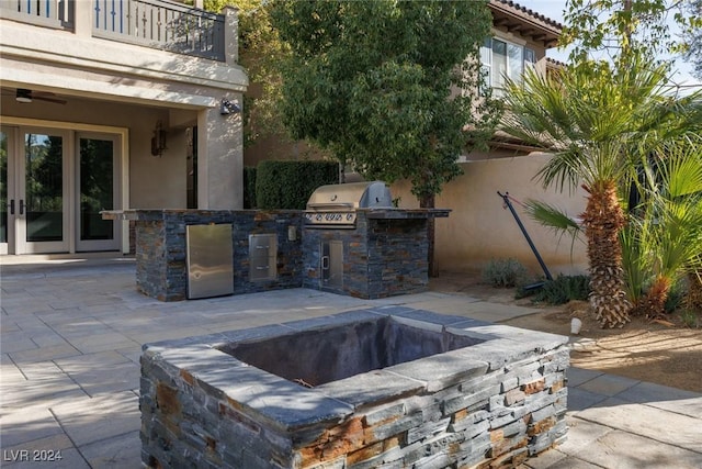 view of patio with a balcony, area for grilling, and a fire pit