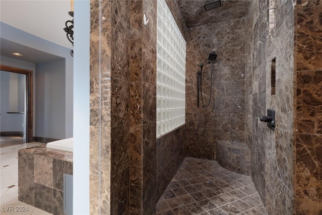 bathroom with a tile shower