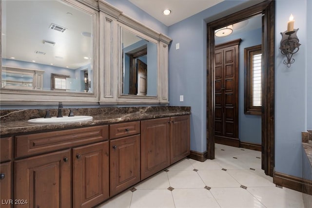 bathroom with vanity and a healthy amount of sunlight