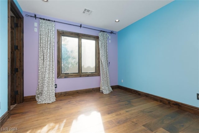 unfurnished room with hardwood / wood-style floors