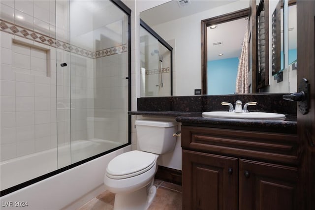 full bathroom with tile patterned floors, vanity, toilet, and shower / bath combination with glass door