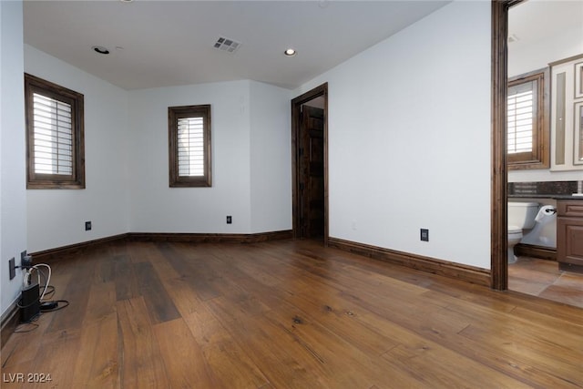 unfurnished room featuring plenty of natural light and light wood-type flooring