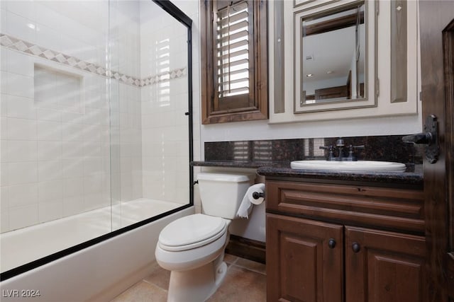 full bathroom featuring tile patterned floors, vanity, enclosed tub / shower combo, and toilet