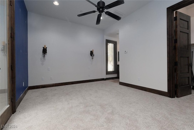 unfurnished room with light carpet and ceiling fan