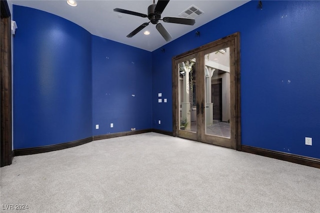 empty room featuring carpet, ceiling fan, and french doors