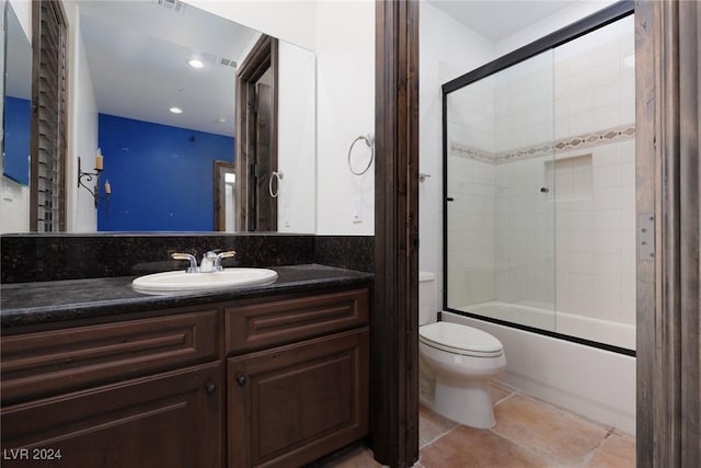 full bathroom featuring combined bath / shower with glass door, vanity, and toilet