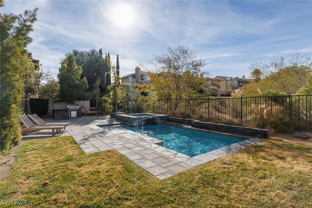 view of pool with a lawn, a patio area, an in ground hot tub, and exterior kitchen