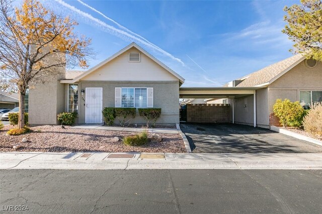 single story home featuring a carport