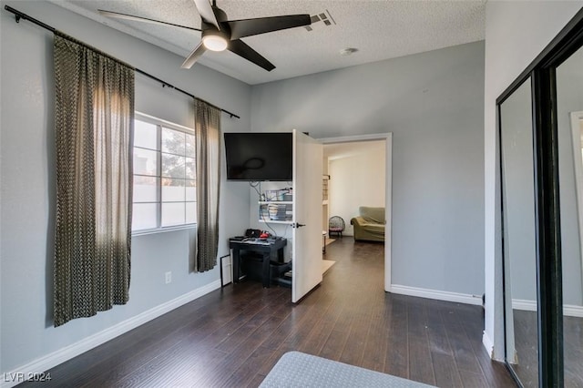 interior space with dark hardwood / wood-style flooring and a textured ceiling