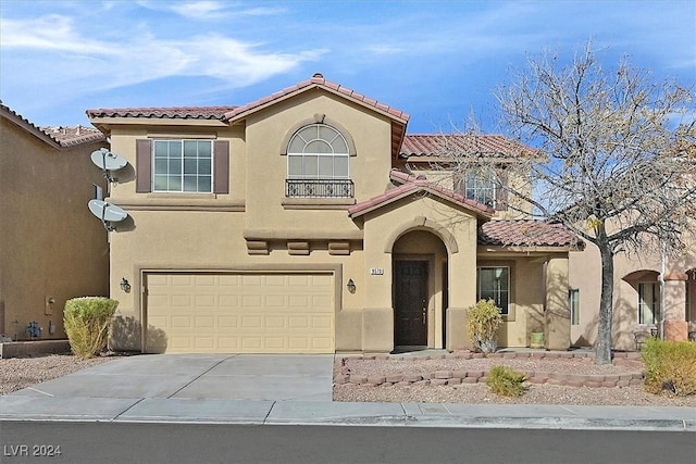 mediterranean / spanish-style home with a garage