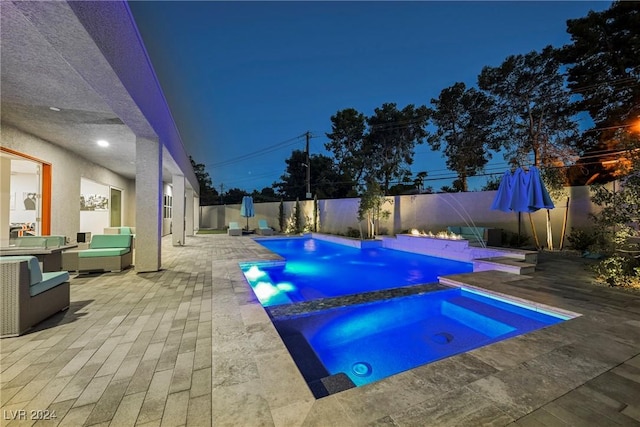 view of pool with an in ground hot tub, pool water feature, and a patio