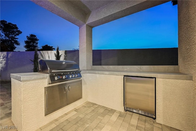 patio terrace at dusk with area for grilling