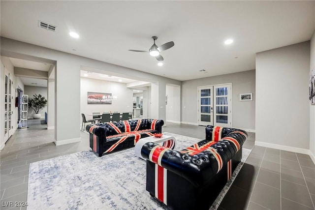 tiled living room featuring ceiling fan and french doors