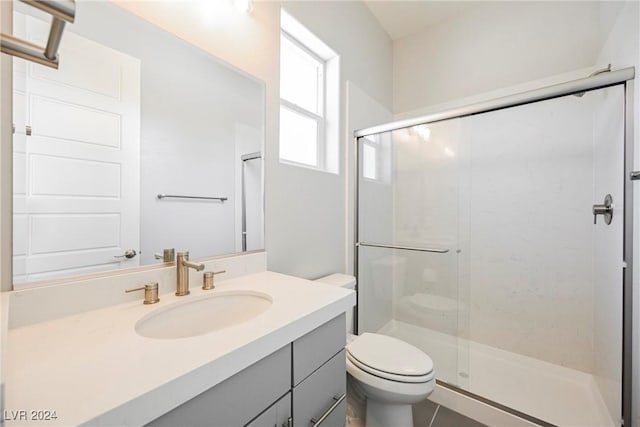 bathroom with vanity, toilet, and walk in shower