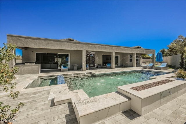 view of pool with pool water feature, an outdoor hangout area, and a patio