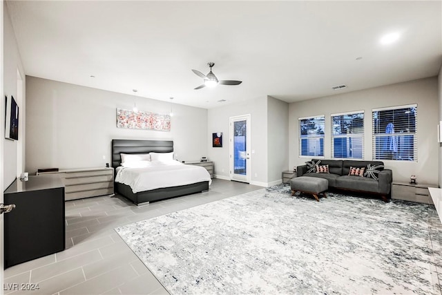 tiled bedroom with access to outside and ceiling fan