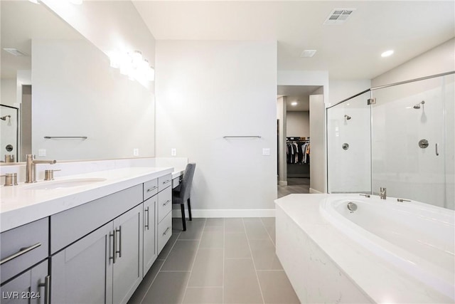 bathroom with tile patterned flooring, vanity, and separate shower and tub