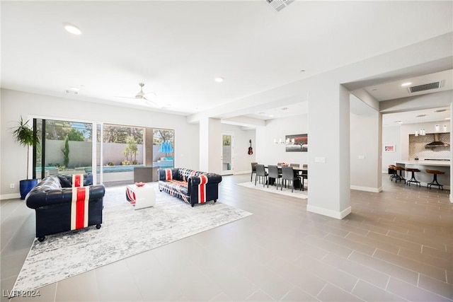 tiled living room with ceiling fan