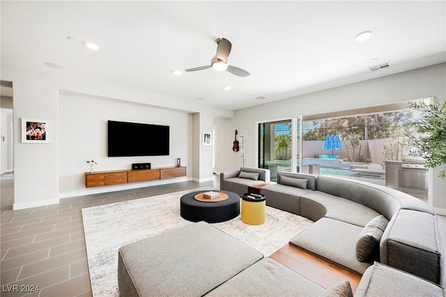 living room with tile patterned flooring and ceiling fan