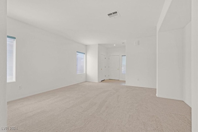 unfurnished room with light colored carpet