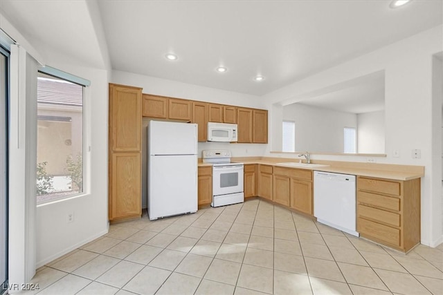 kitchen featuring sink, light tile patterned flooring, and white appliances