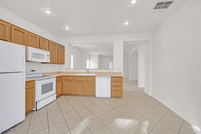 kitchen with white appliances, sink, and light tile patterned floors