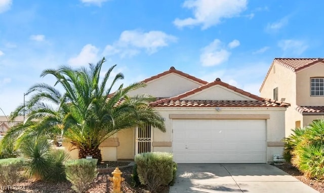 mediterranean / spanish-style home with a garage