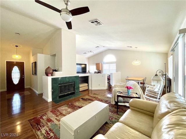 living room featuring a tile fireplace, ceiling fan, dark hardwood / wood-style flooring, and lofted ceiling