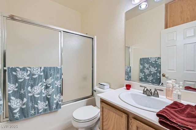 full bathroom featuring shower / bath combination with glass door, vanity, and toilet