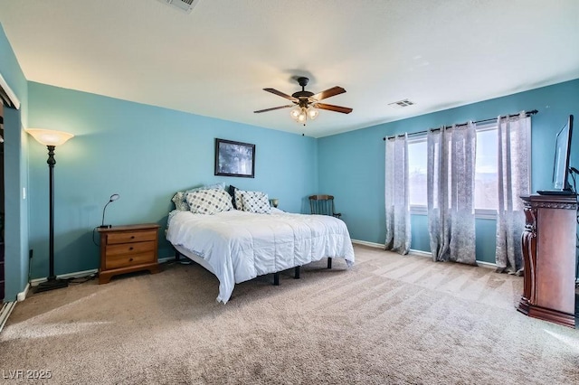 bedroom with carpet floors, visible vents, ceiling fan, and baseboards