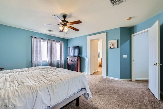 bedroom featuring carpet floors, visible vents, baseboards, and ensuite bathroom