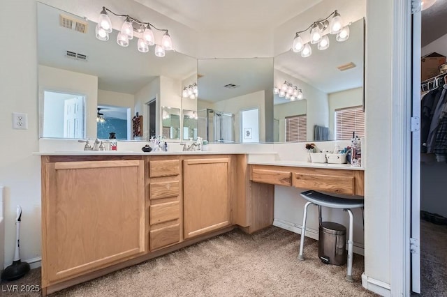 bathroom featuring ceiling fan, a shower with door, and vanity