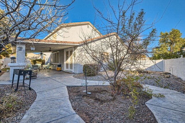 6019 Orca Lilly St, North Las Vegas, NV 89031 - rear view of house with stucco siding, a patio area, a fenced backyard, and ceiling fan