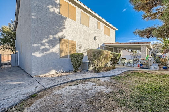 6019 Orca Lilly St, North Las Vegas, NV 89031 - rear view of house featuring stucco siding, ceiling fan, fence, and a patio