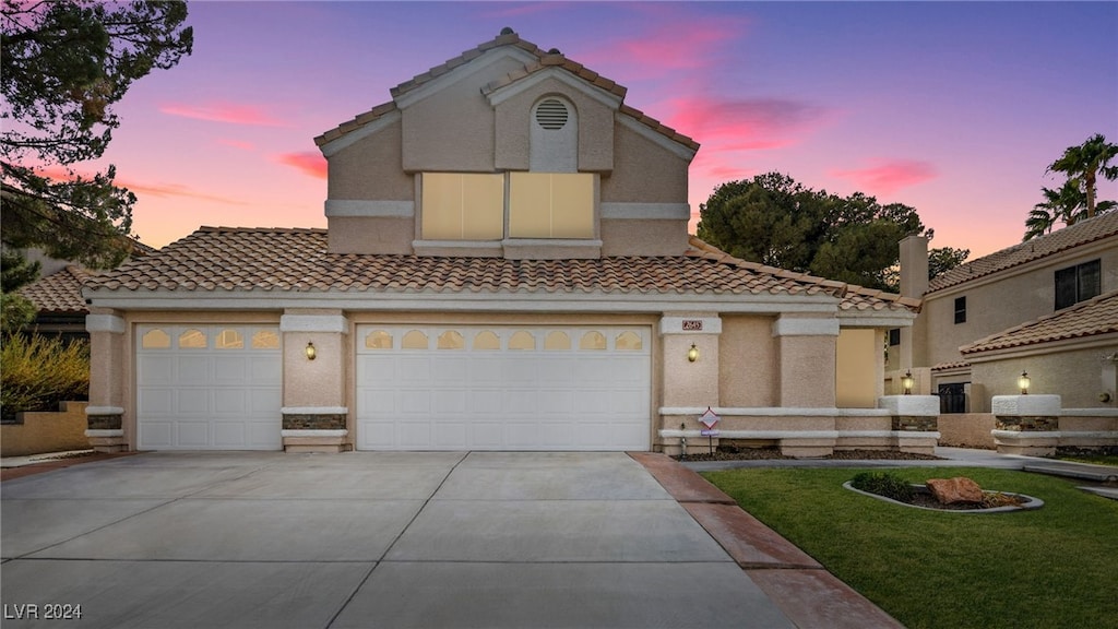 mediterranean / spanish house with a garage