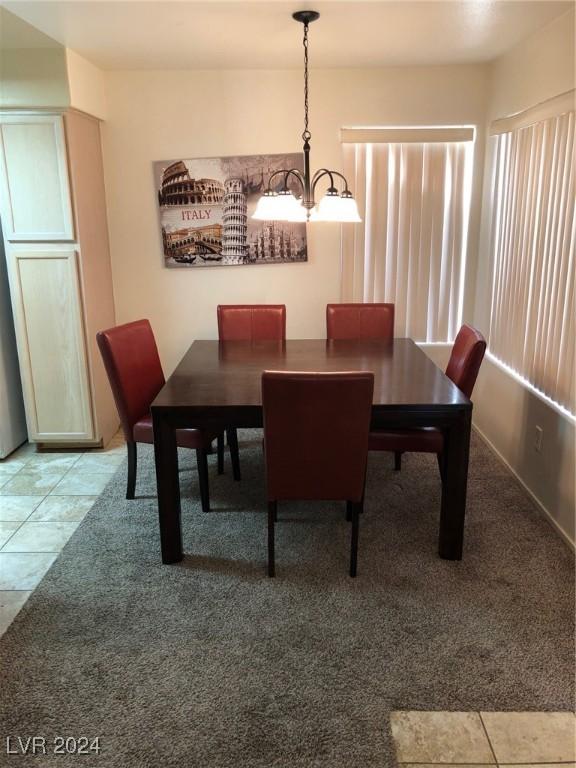 dining area featuring an inviting chandelier and tile patterned floors