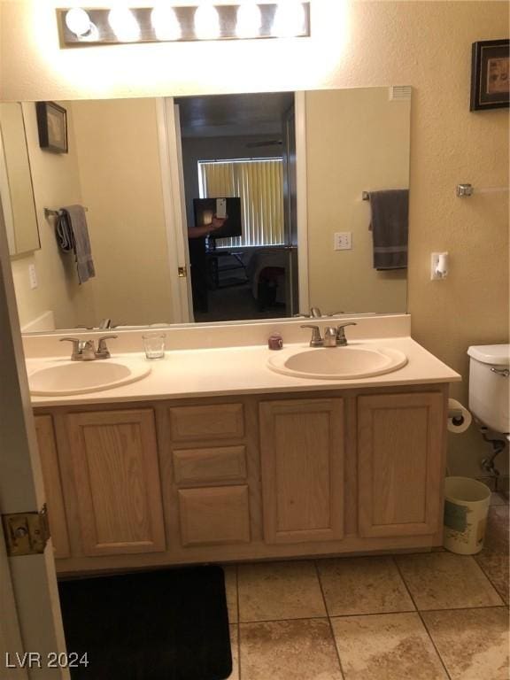 bathroom with tile patterned floors, vanity, and toilet