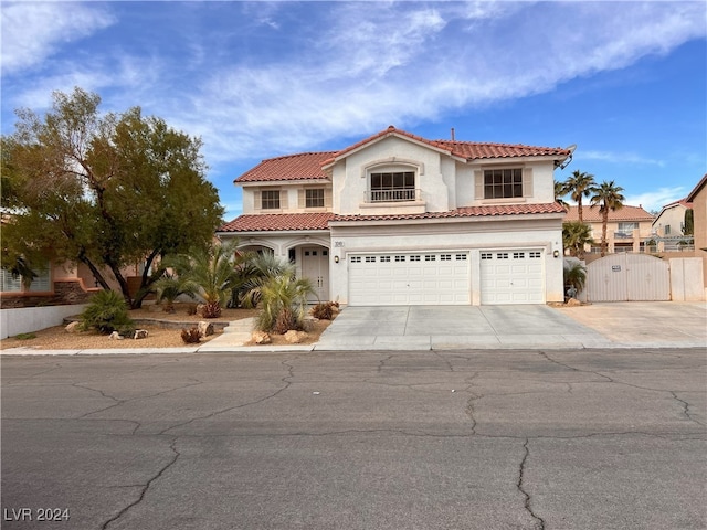 mediterranean / spanish home with a garage