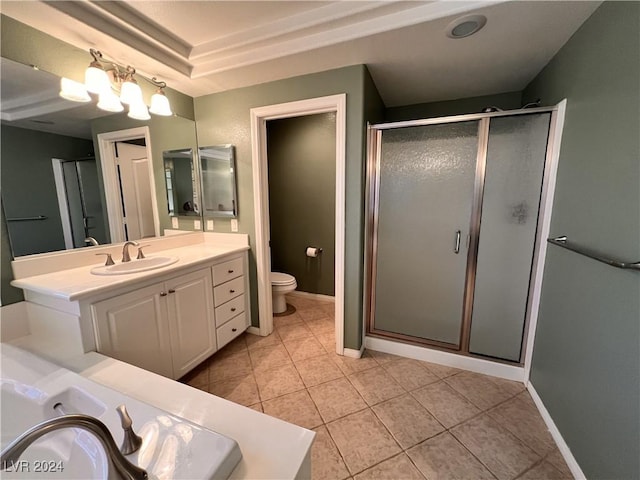 bathroom with tile patterned flooring, vanity, a shower with shower door, and toilet