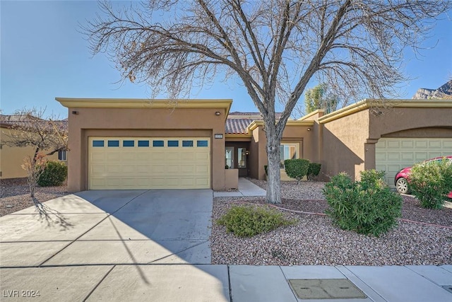 pueblo-style home featuring a garage