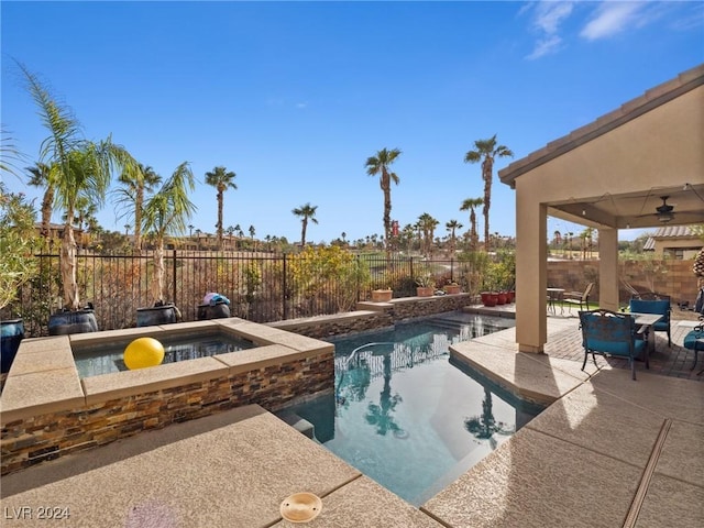 view of pool with ceiling fan, an in ground hot tub, and a patio area