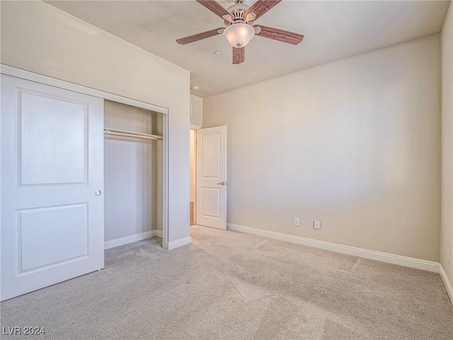 unfurnished bedroom with a closet, ceiling fan, and light colored carpet