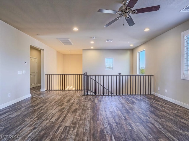 empty room featuring ceiling fan and dark hardwood / wood-style flooring