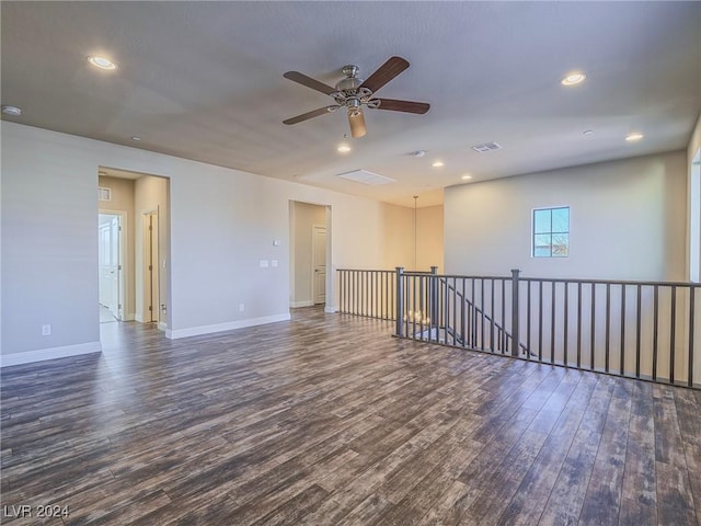 spare room featuring ceiling fan and dark wood-type flooring